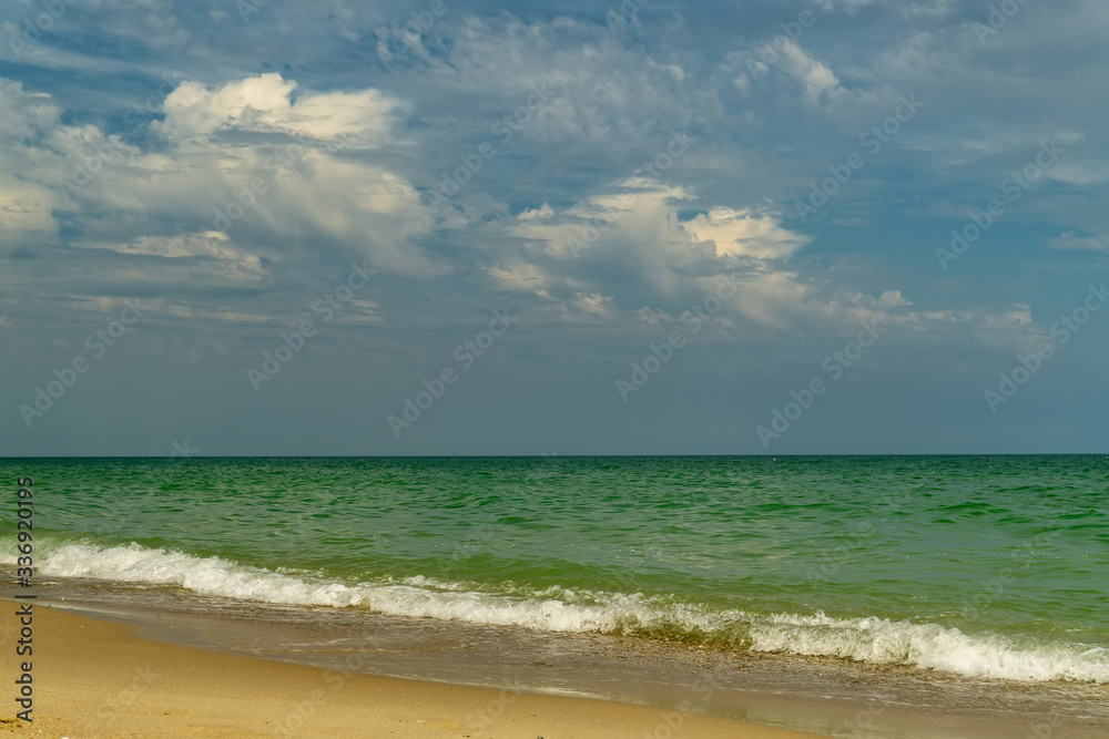 Sea view from tropical beach with sunny sky.