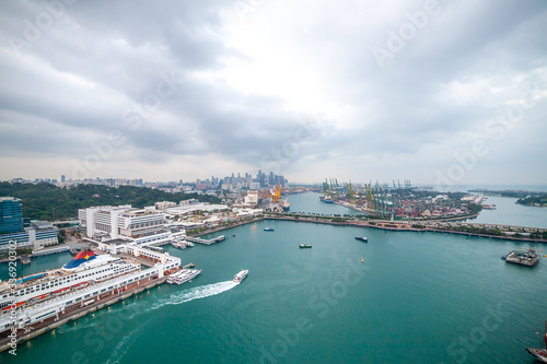 Seaport in Singapore with a Large Cruise Liner, Boats and Cranes in the Background. Keppel Harbour or Keppel Channel