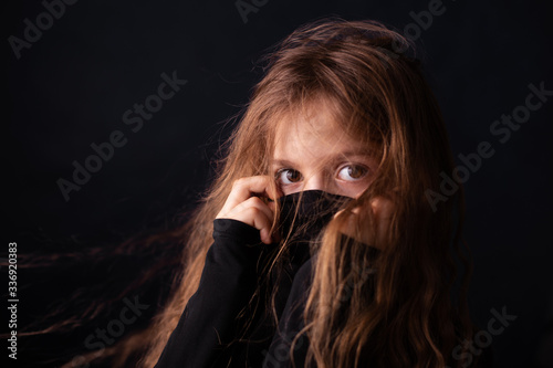A girl with her face hidden in a black cloth