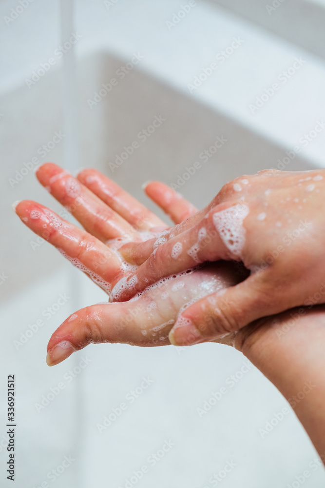 Fototapeta premium Close-up of woman rubbing hands with a soap.