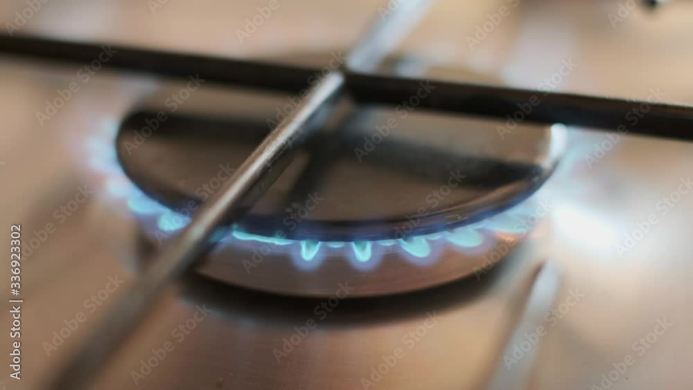 Gas burner firing up in kitchen 4k. Gas burner firing up in kitchen 4k.
