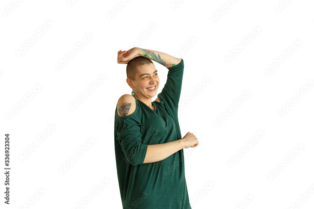 Dancing. Portrait of young caucasian woman with freaky appearance on white background. Unusual look with tattoos and bald. Human emotions, facial expression,sales, ad concept. Youth culture. Dancing. Portrait of young caucasian woman with freaky appearance on white background. Unusual look with tattoos and bald. Human emotions, facial expression,sales, ad concept. Youth culture.
