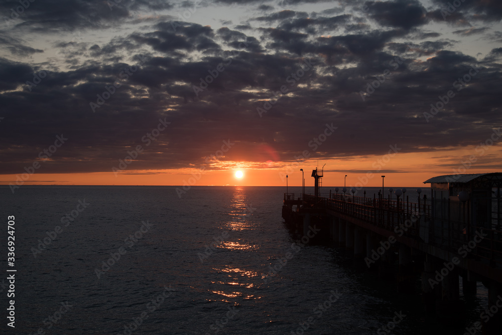 Fototapeta premium Beautiful sea sunset in warm colors. Postcard
