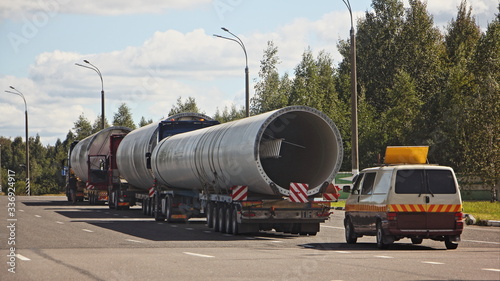 Obraz na plátně Long oversized cargo transportation logistics, big large pipes on 5-axle lowbed