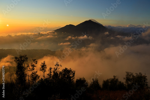 Scenic view of clouds and mist at sunrise from the top of mount Batur (Kintamani volcano), Bali, Indonesia.