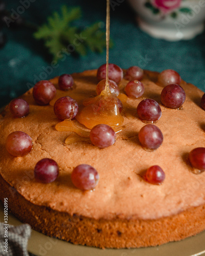 pie decorated with grapes and honey