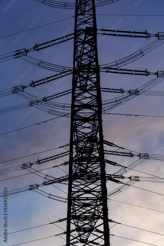 silouette of a power pole in the blue twilight silouette of a power pole in the blue twilight