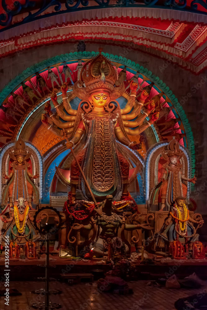 Idol of Goddess Devi Durga at a decorated puja pandal in Kolkata, West Bengal, India. Durga Puja is a popular and major religious festival of Hinduism that is celebrated throughout the world.
