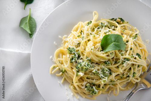 pasta, spinach spaghetti on a white plate