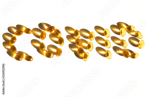 The text "Covid" is set out from cod liver capsules isolated on white