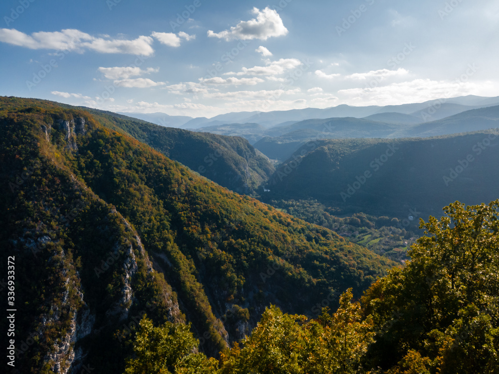 Aerial view of mountains by the canyon of Unac river near the Martin Brod in Bosnia and Herzegovina. Autumn colors on plants and trees in fall on slopes of mountain Osjecenica.