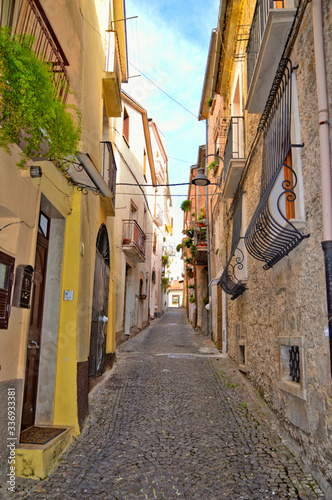 A narrow street between the colorful houses of Capriati al Volturno, a village in the province of Caserta, Italy photo