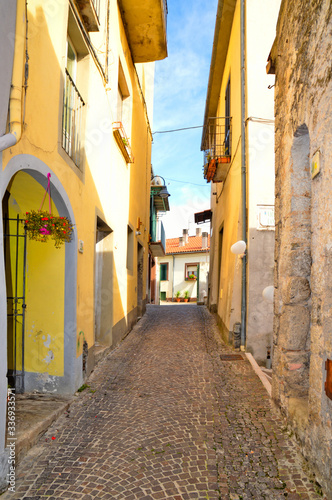 A narrow street between the colorful houses of Capriati al Volturno  a village in the province of Caserta  Italy