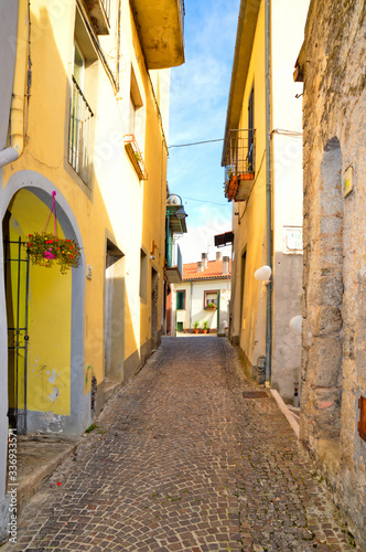 A narrow street between the colorful houses of Capriati al Volturno, a village in the province of Caserta, Italy photo