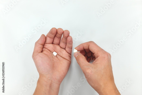 Obraz na plátne Half medicine pill on hand palm