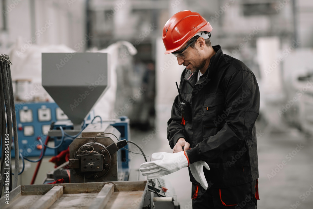 Portrait of worker in factory. Young handsome man working in factory. Portrait of worker in factory. Young handsome man working in factory.