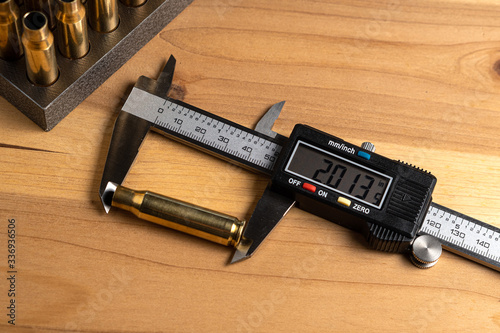 Production of cartridges for a rifle, reload. Measurement of the empty cartridges with a caliper. Top view