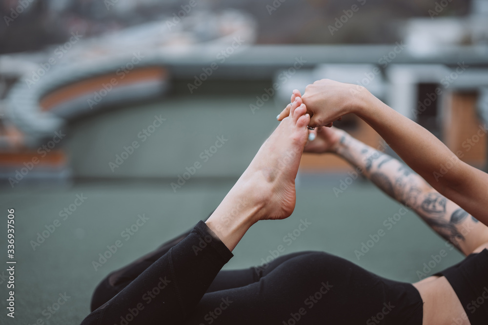 Woman practicing yoga on the roof and doing yoga exercises