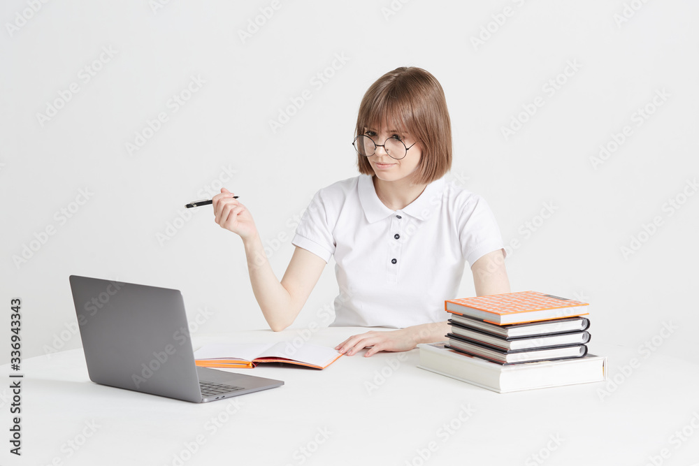 Cool happy girl goes through online training sitting at home. Remote school education on a laptop. Stay home lessons. Cool happy girl goes through online training sitting at home. Remote school education on a laptop. Stay home lessons.