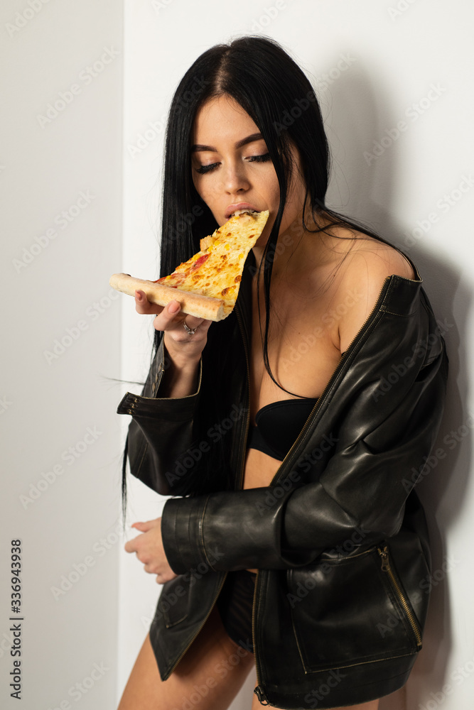 Sexual appetite. Sexy girl eating pizza. Pizza delivery. Restaurant food.  Attractive woman leather jacket naked body eating pizza. Tempting dish.  Seductive meal. Fast food. Diet and healthy body Stock Photo | Adobe
