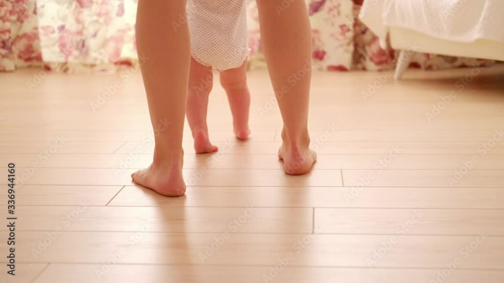 baby first step with mother in children's room baby first step with mother in children's room