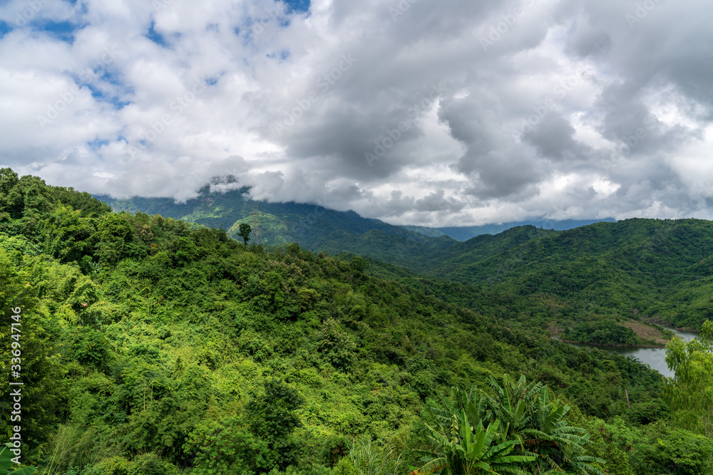 Fototapeta premium beautiful blue sky high peak mountains mist fog wildlife green forest at Khao Koh, Phu Tub Berk, Phetchabun, Thailand guiding idea long weekend for backpacker camping campfire relaxing hiking
