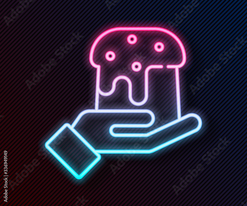 Glowing neon line Human hand and easter cake icon isolated on black background. Happy Easter. Vector Illustration