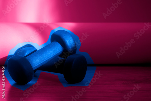 Healthy background fitness equipment, Dumbbell on wooden floor. Healthy lifestyle, sport concept. Pink and pink frame color filter