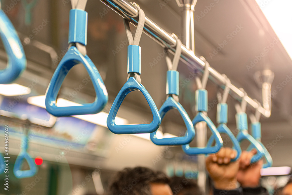 Close-up Subway or Metro Handrail, Hand holding blue Handrail	