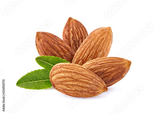 Almonds with leaves in closeup isolated on white background.