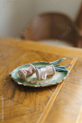 two silk ribbons on a vintage plate with olive branch on the table