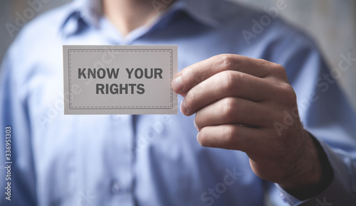 Man showing Know Your Rights text in business card.