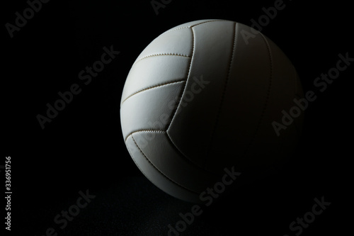 volleyball ball with shadow on black background with copy space