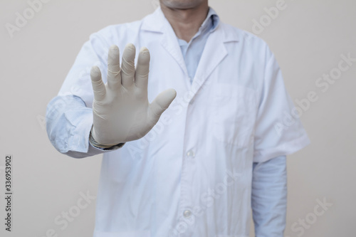 Doctor showing STOP hand sigh for communication banner in disease crisis