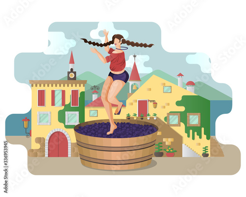 Beautiful young woman is crushing grapes with her feet while dancing in large wooden vat on the background of Italy village