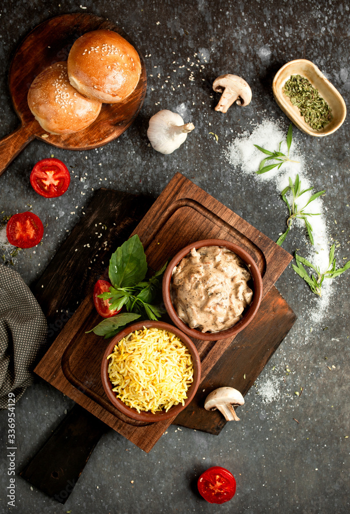 rice in pottery and mushrooms in a creamy sauce