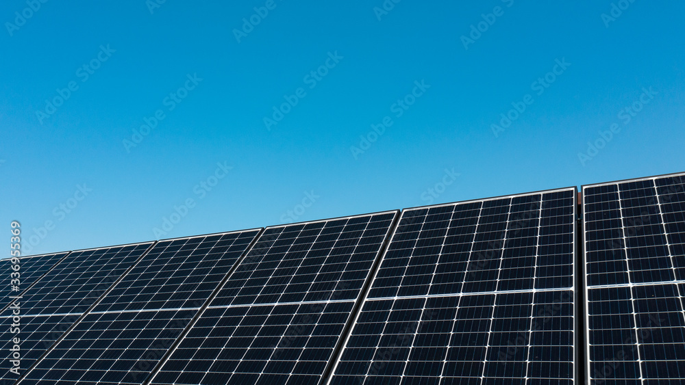 Background of photovoltaic modules for renewable energy. Huge solar panels with clear blue sky. Background of photovoltaic modules for renewable energy. Huge solar panels with clear blue sky.