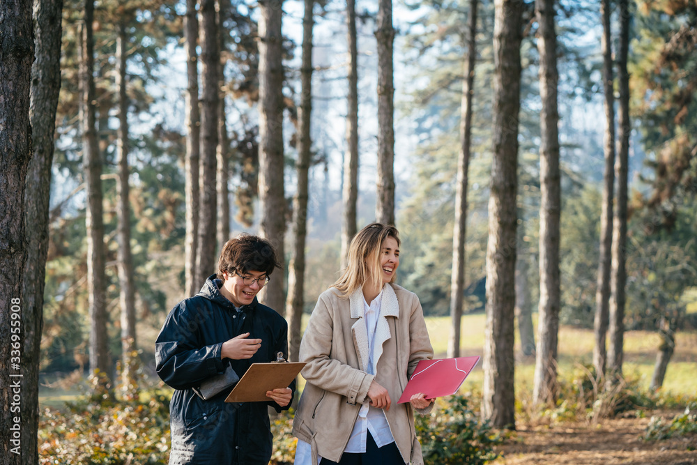 Scientists are studying plant species and inspect trees in the forest. Scientists are studying plant species and inspect trees in the forest.