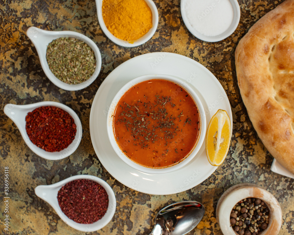 top view of lentil soup garnished with dried mint and lemon