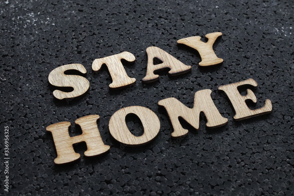 Social distancing concept, stay home words written with wooden alphabet. Covid 19 coronavirus prevention Social distancing concept, stay home words written with wooden alphabet. Covid 19 coronavirus prevention
