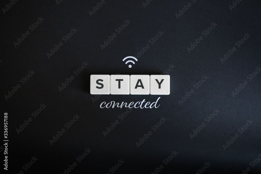 Obraz premium Stay connected concept. Block letters, wifi icon and cursive font on black background. Minimal aesthetics.