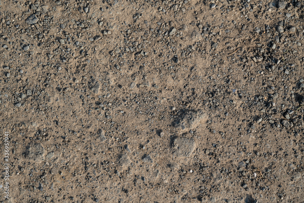 Texture of flatted dry soil as walking road with rocks Texture of flatted dry soil as walking road with rocks