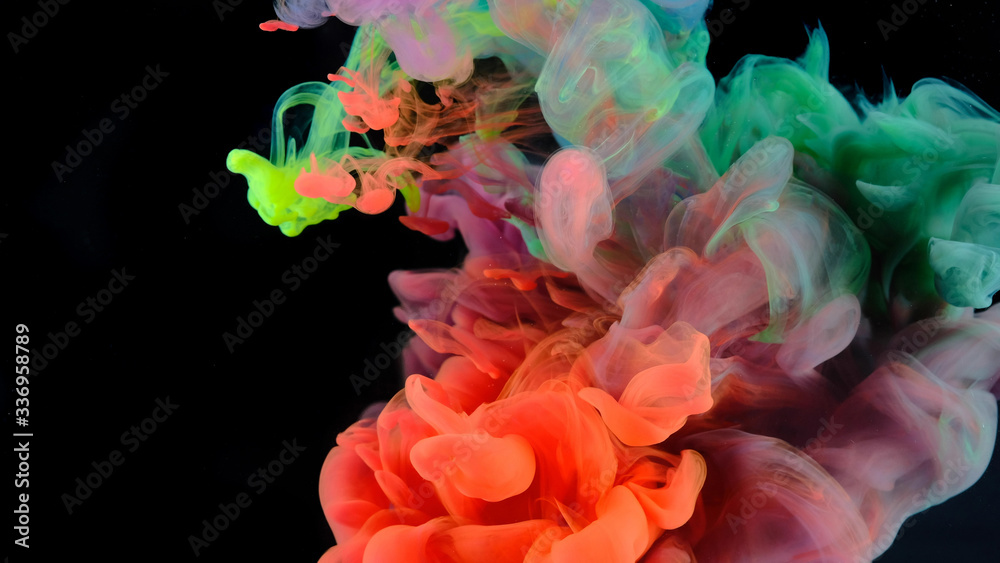 Obraz premium Color paint drops in water , abstract color mix , drop of Ink color mix paint falling on water Colorful ink in water, 