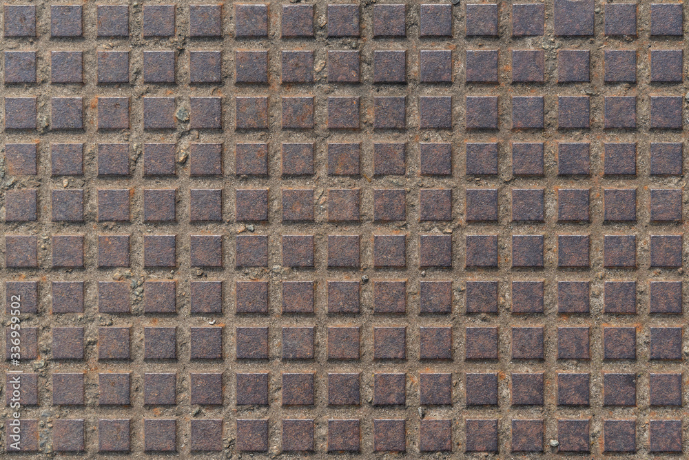 Texture of metal squares on a rusted metal plate Texture of metal squares on a rusted metal plate