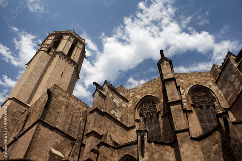 Bottom view of historical, famous Barcelona cathedral. It is the 15th century Gothic cathedral and seat of the Archbishop of Barcelona, Catalonia, Spain. It is a sunny summer day. photo