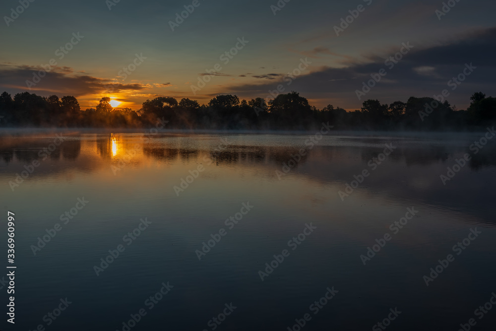 Bronze sunrise over the lake near the Joseph-Volotsky Monastery. The cloister is located in the village of Teryaevo, Volokolamsk municipal district of the Moscow region.