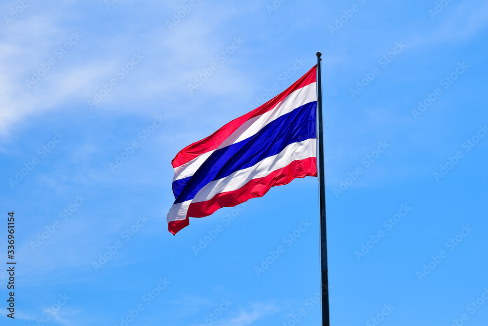 Thailand national flag waving in the wind against to blue sky