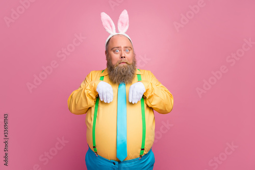Portrait of his he nice funky bearded guy wearing bunny ears white gloves pretending making paws like rabbit isolated over pink pastel color background