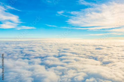 Bright beautiful sky with an airplane window.