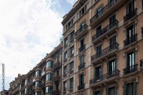 View of historical  traditional  typical buildings showing Spanish   Catalan architectural style in Barcelona. It is a summer day.